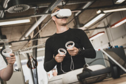 Actionfoto af medarbejder med VR-headset og controllere – brandingfoto til tech- og innovationsvirksomhed